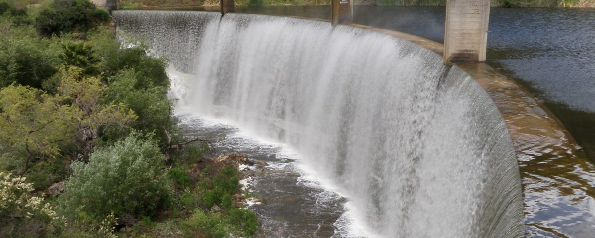 water flowing over a dam